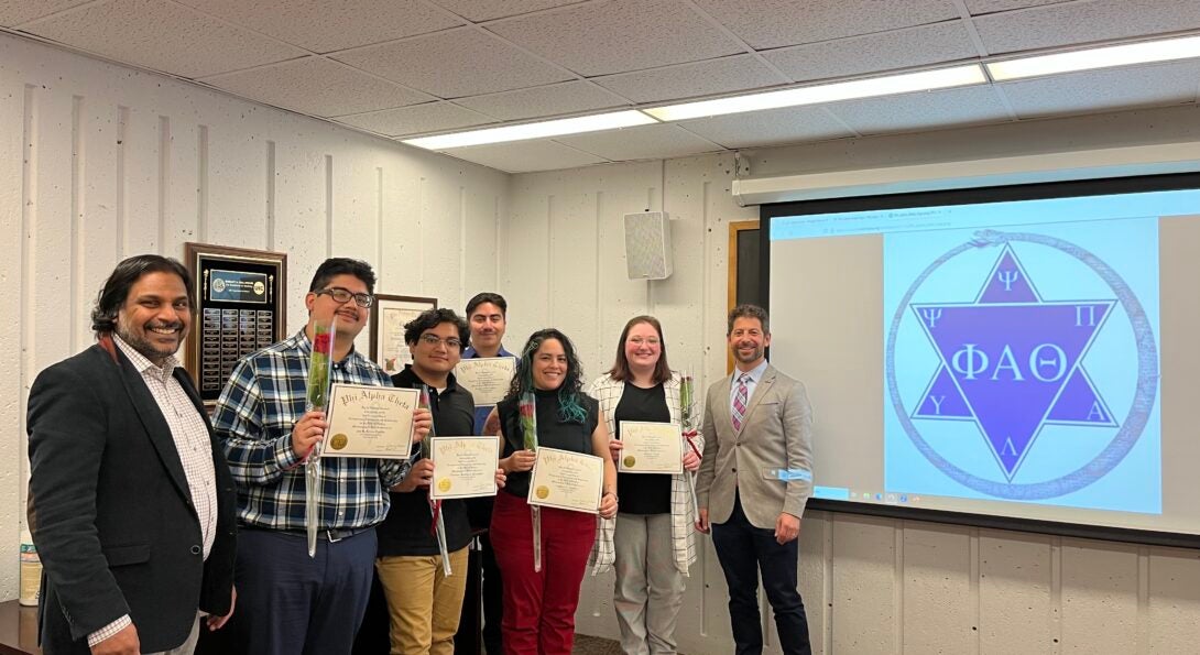 Professors Quadri & Schultz with five student inductees